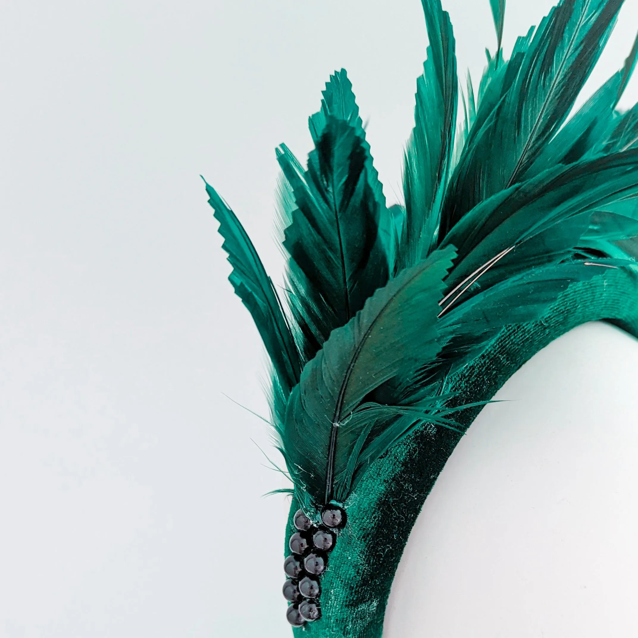 Dark emerald green feather padded velvet headband fascinator
