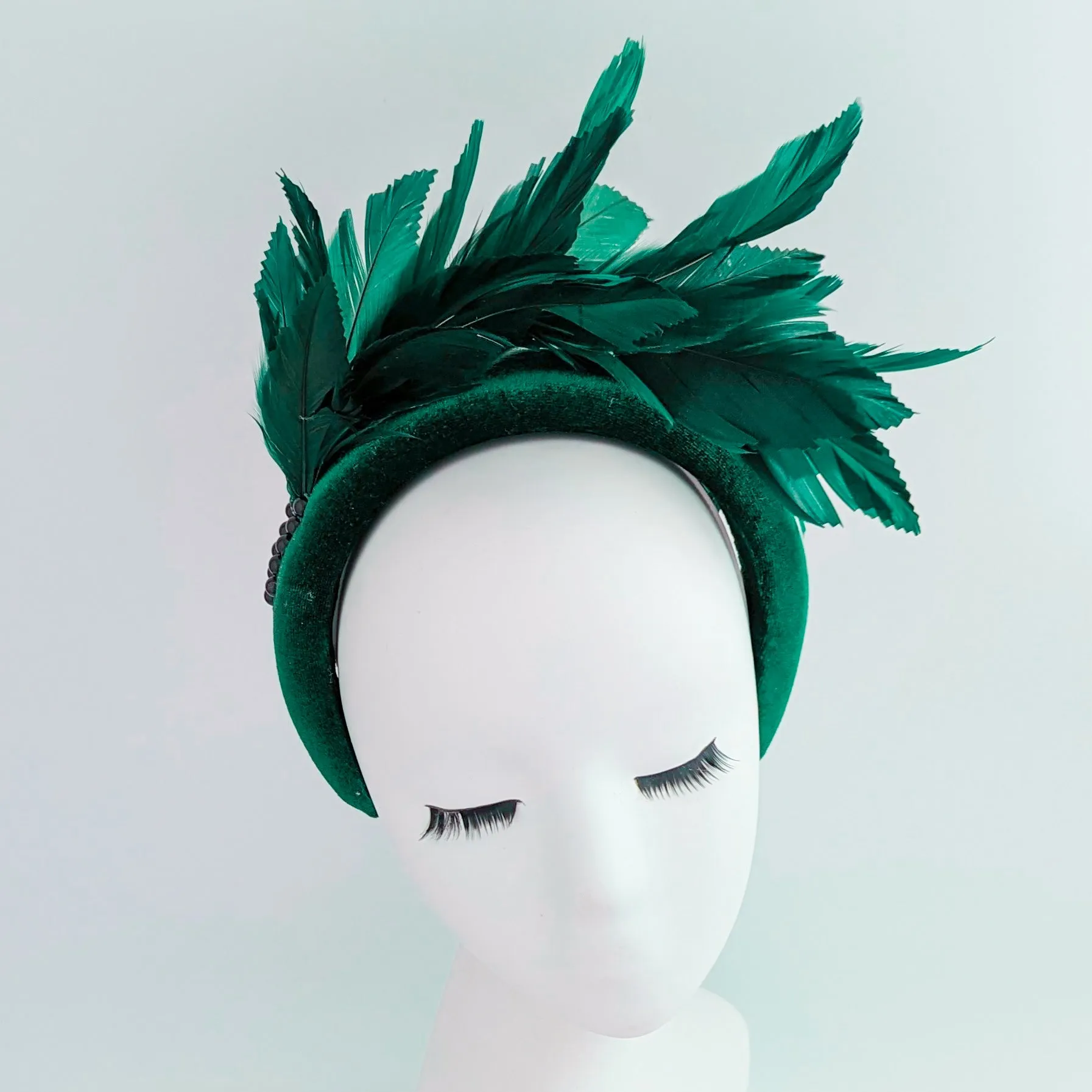 Dark emerald green feather padded velvet headband fascinator