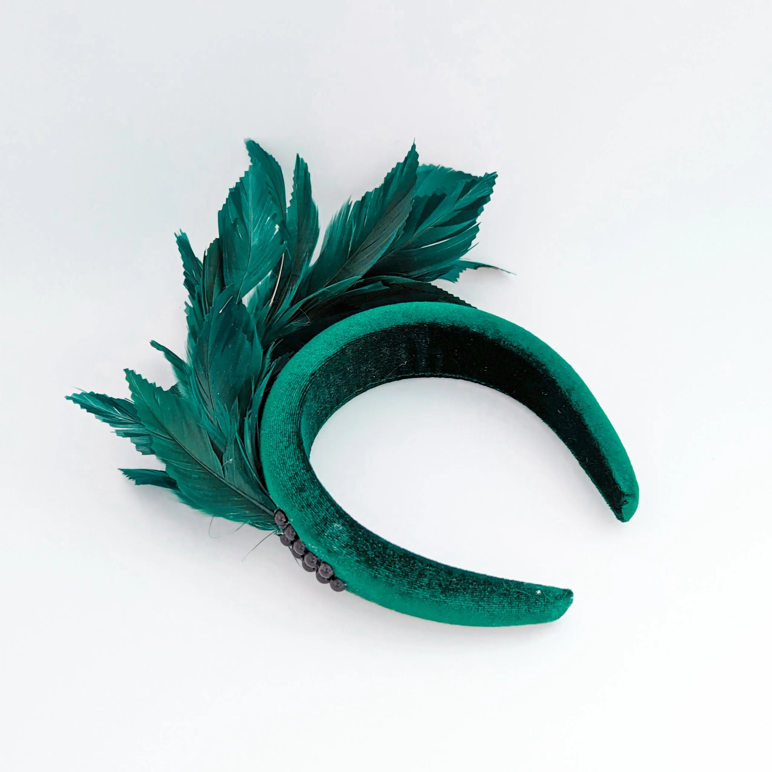 Dark emerald green feather padded velvet headband fascinator