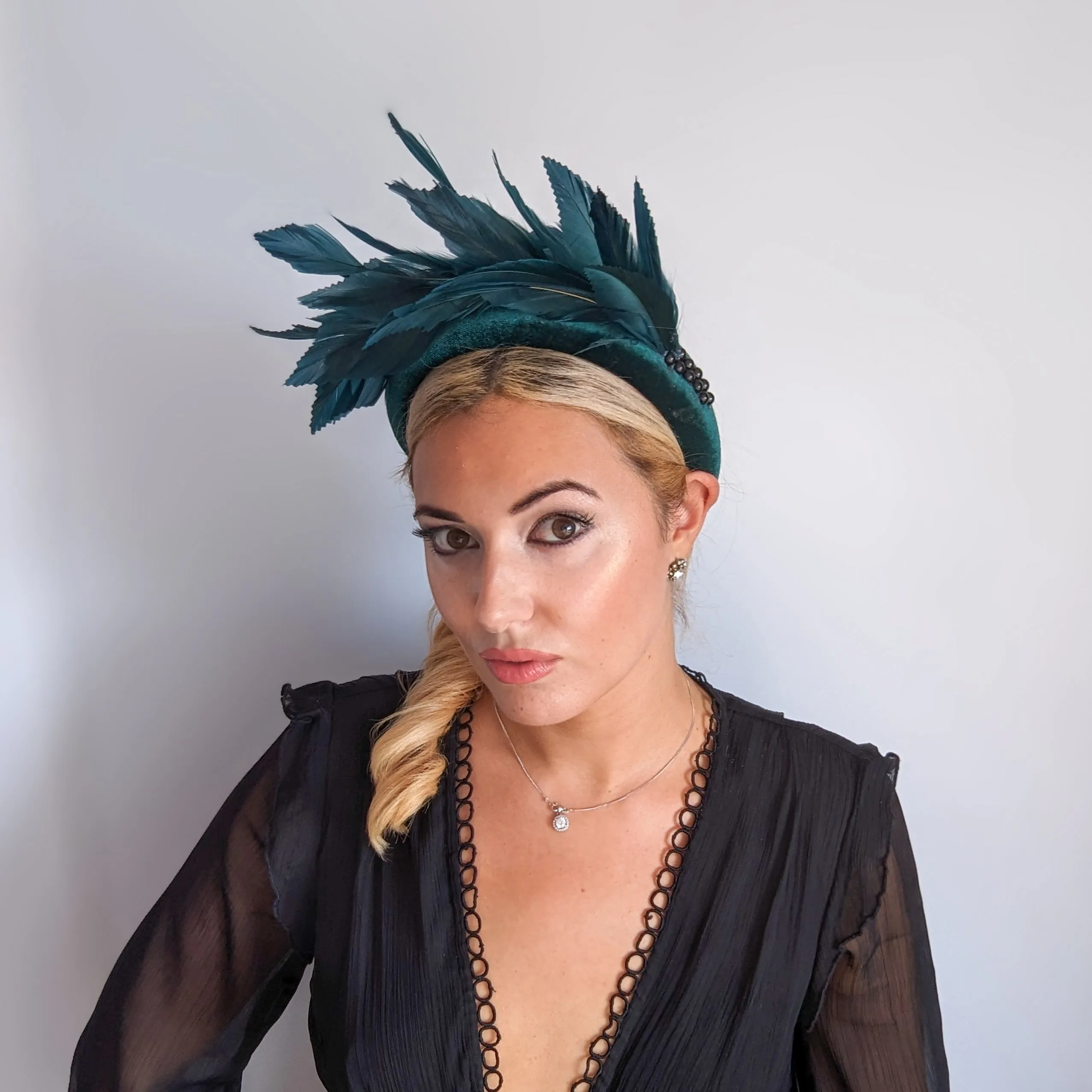Dark emerald green feather padded velvet headband fascinator