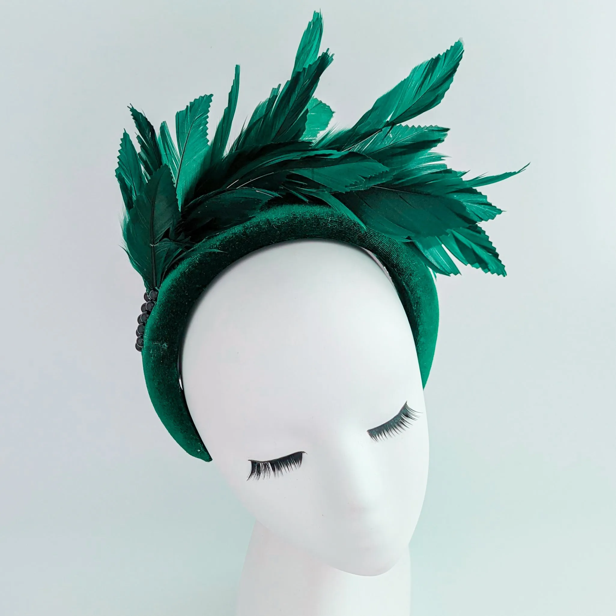 Dark emerald green feather padded velvet headband fascinator